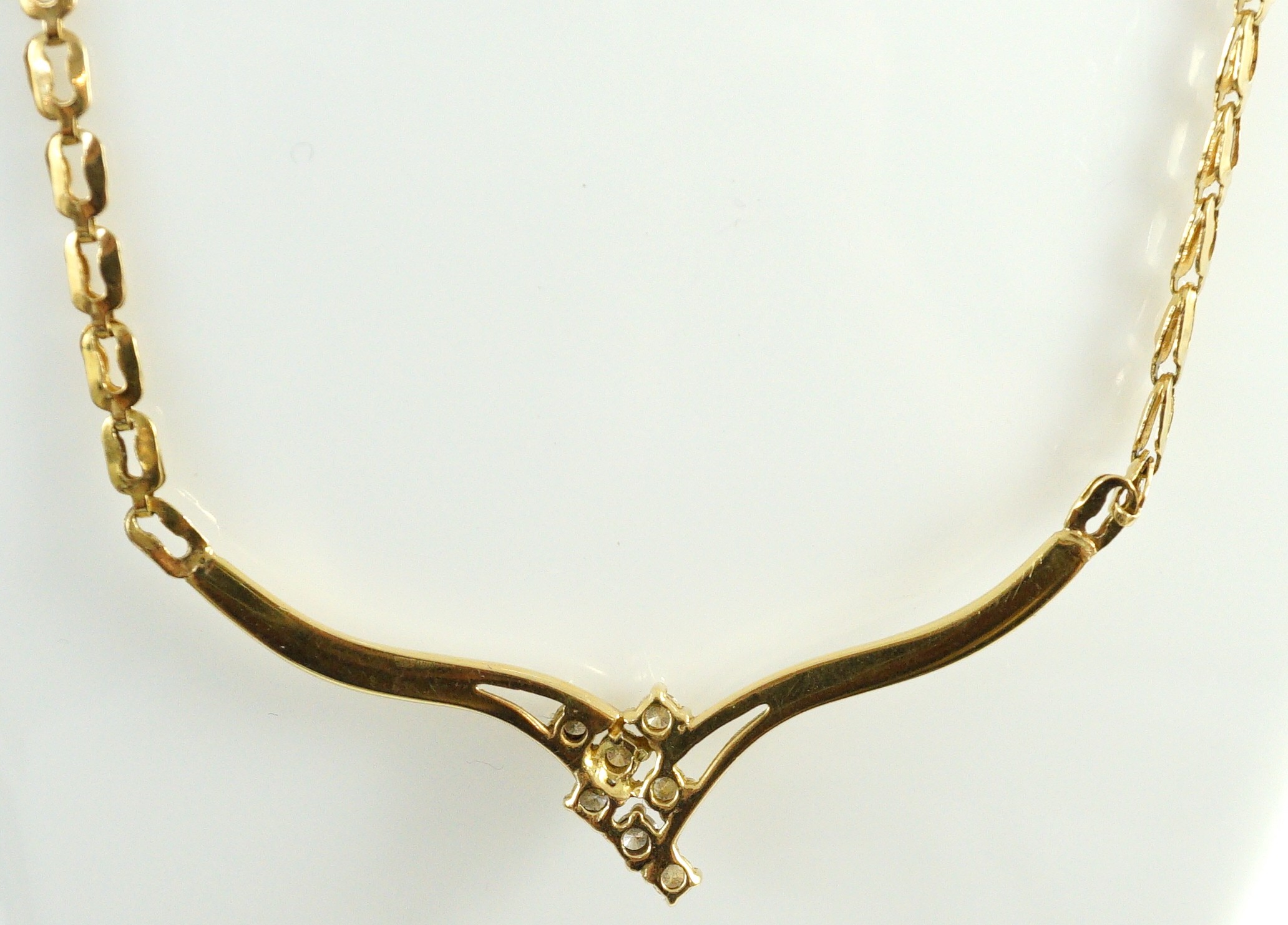 A modern 18k gold and seven stone diamond cluster set necklace